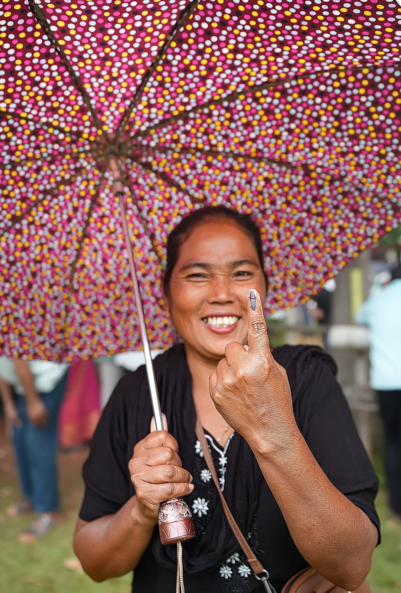 A voter shows her inked finger after voting in Assam, April 2026